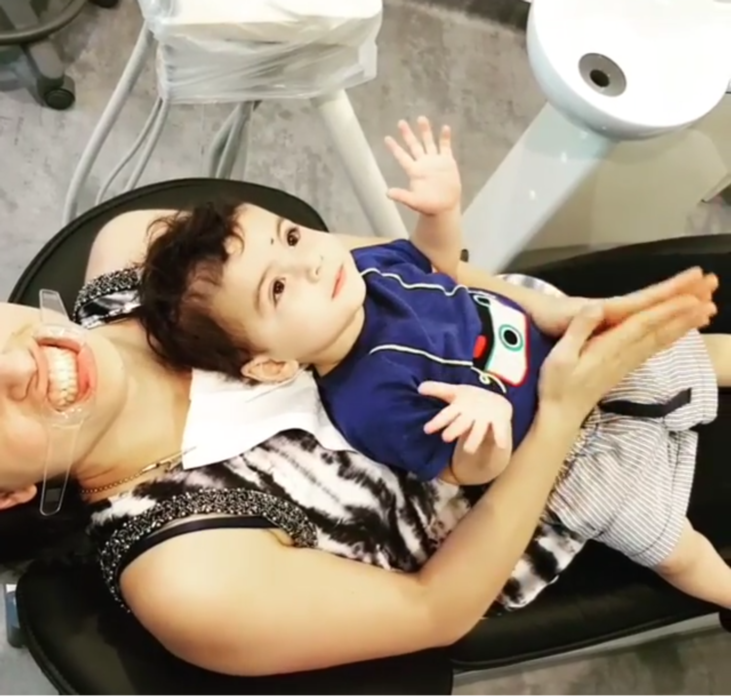 Child sitting on mom's lap at dental office | Dentist Glenroy VIC